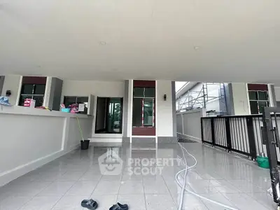 Spacious covered terrace with modern design and tiled flooring, perfect for outdoor relaxation.