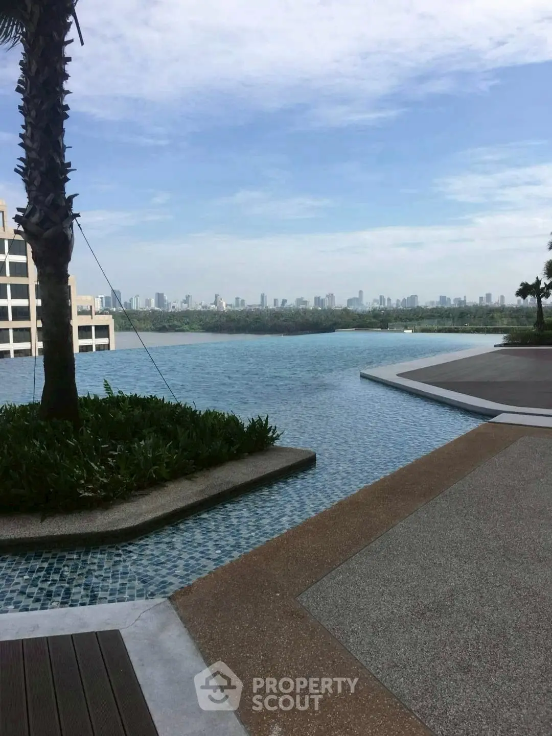 Luxurious infinity pool with stunning city skyline view, perfect for relaxation and leisure.