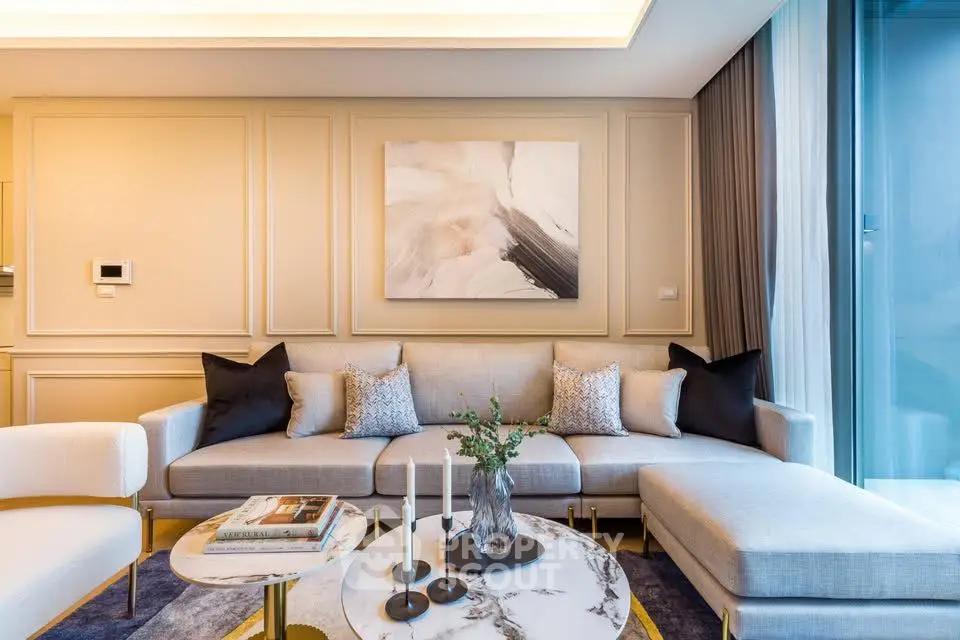 Luxurious modern living room with elegant decor and large windows.