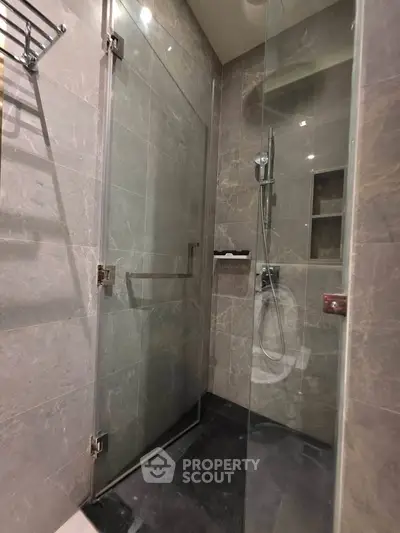Modern bathroom with glass shower enclosure and sleek tile design