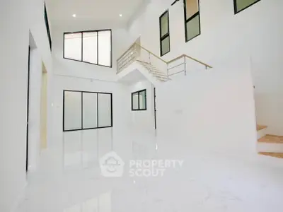 Spacious modern living room with high ceilings and large windows