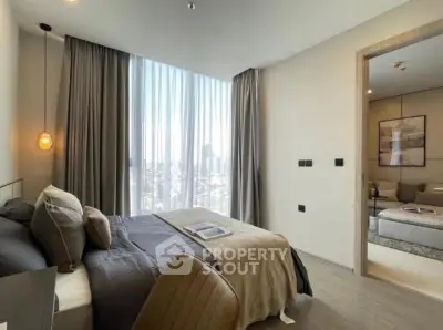Modern bedroom with large window and city view, featuring stylish decor and cozy ambiance.