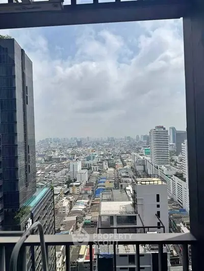 Stunning cityscape view from high-rise balcony showcasing urban skyline and architecture.