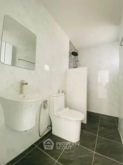 Modern bathroom with sleek fixtures and marble walls