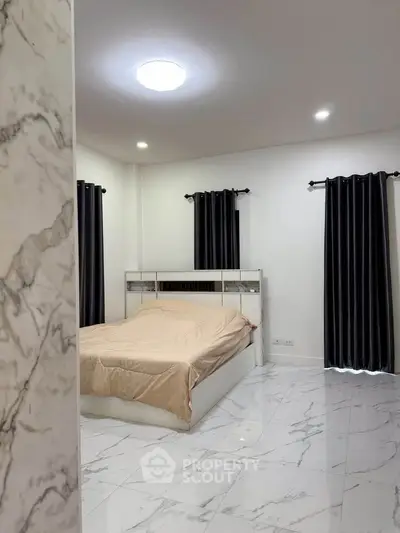 Spacious bedroom with modern marble flooring and elegant curtains