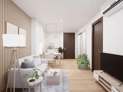 Modern living room with stylish decor and open layout, featuring a cozy sofa and elegant lighting.