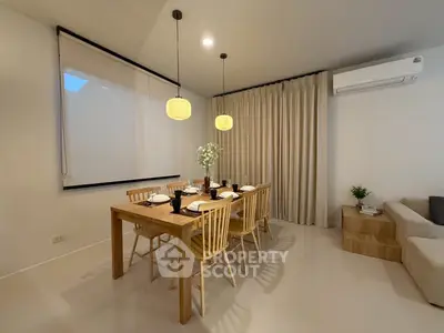 Elegant dining area with wooden table and chairs, modern lighting, and cozy ambiance.