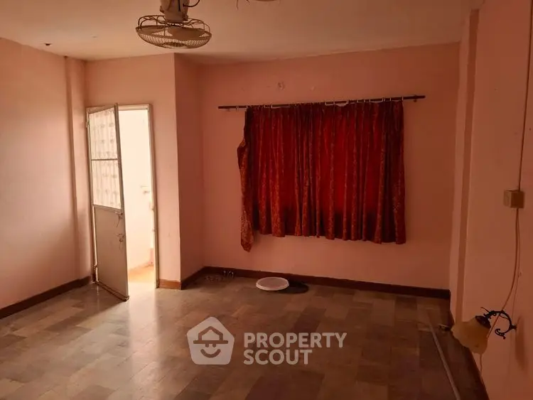 Spacious empty room with red curtains and tiled floor, ready for customization.