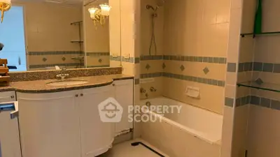 Spacious bathroom with elegant fixtures and built-in bathtub in modern apartment.