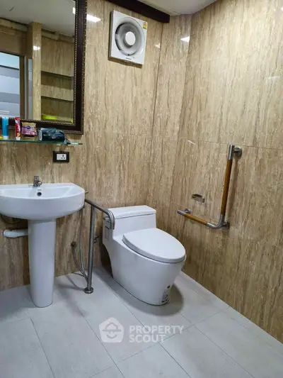 Modern bathroom with elegant marble walls and sleek fixtures