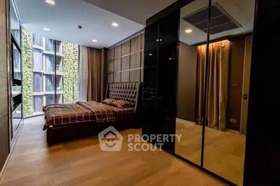 Luxurious bedroom with floor-to-ceiling windows and modern decor