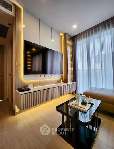 Modern living room with sleek design, large TV, and floor-to-ceiling windows for natural light.