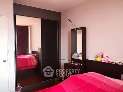 Cozy bedroom with modern furniture and vibrant pink bedding