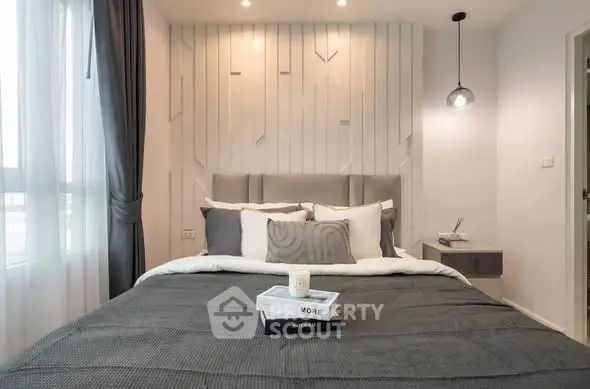 Modern bedroom with stylish decor and cozy ambiance, featuring elegant lighting and plush bedding.