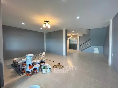Spacious modern living room with fresh paint and elegant lighting, perfect for customization.
