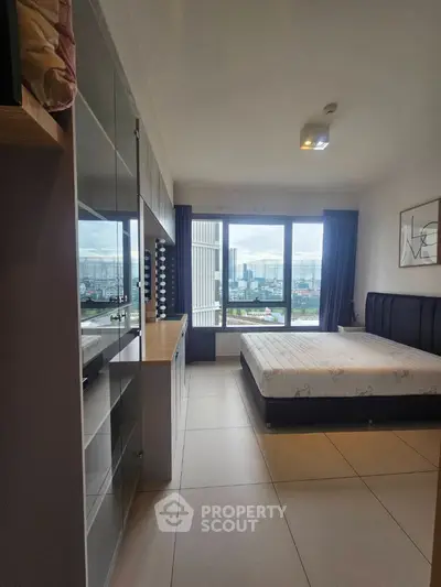 Spacious bedroom with city view and modern furnishings