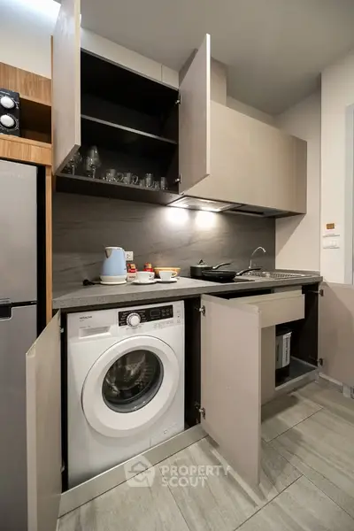 Modern kitchen with integrated washing machine and sleek cabinetry