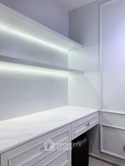 Elegant study room with modern white cabinetry and ambient lighting