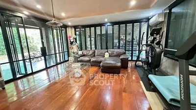 Spacious living room with modern decor and exercise equipment, perfect for relaxation and fitness.