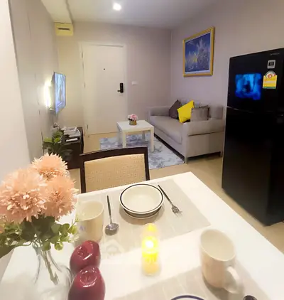 Cozy living room with modern decor, dining area, and stylish furniture in a contemporary apartment.