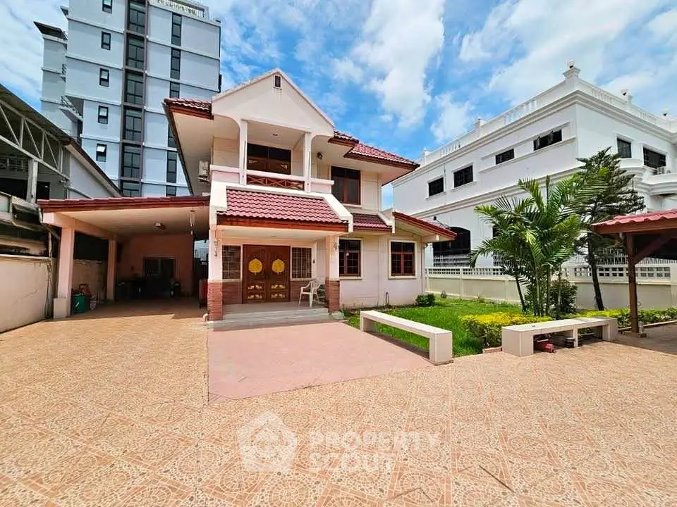Charming two-story house with spacious driveway and lush garden in a serene neighborhood.