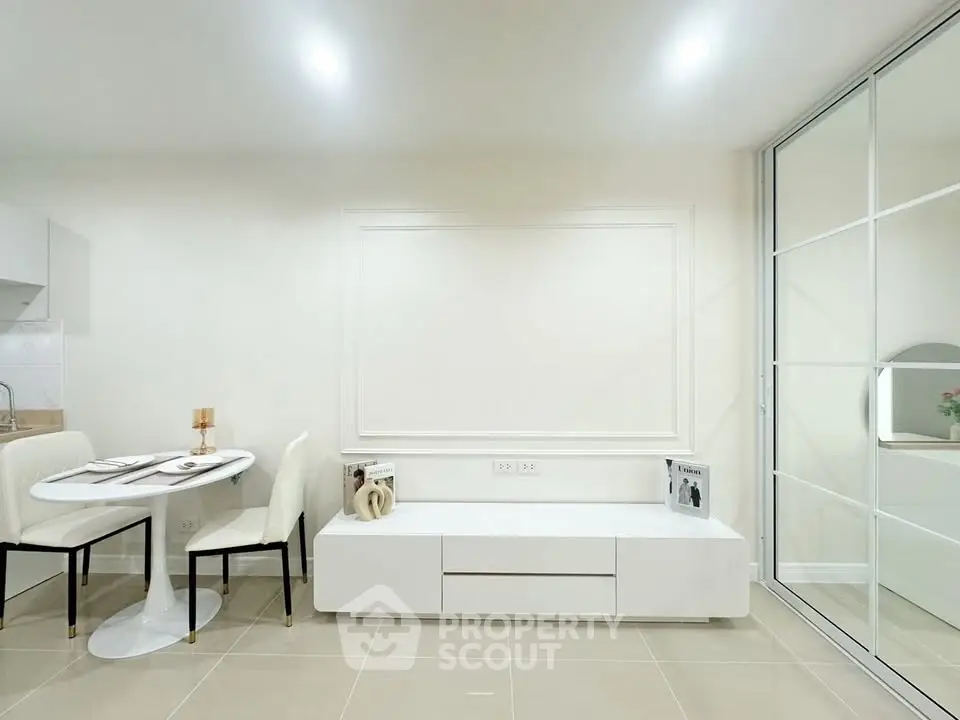 Modern minimalist living room with sleek white furniture and elegant dining area