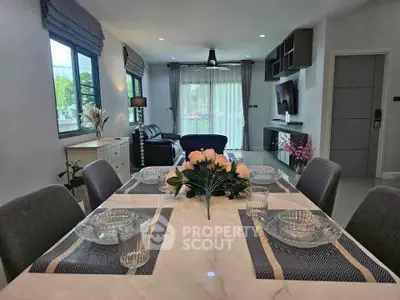 Elegant dining area with modern decor and cozy living room view