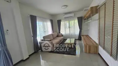 Spacious living room with modern furniture and large windows for natural light.