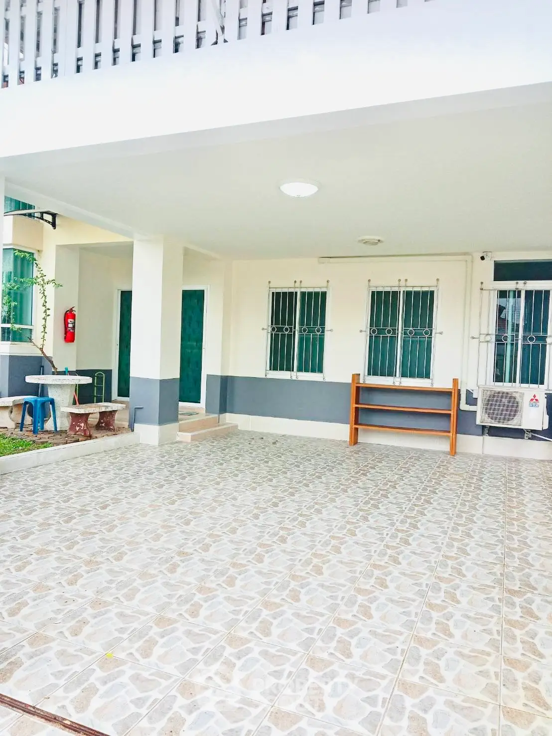 Spacious outdoor area with tiled flooring and modern design, perfect for gatherings and relaxation.
