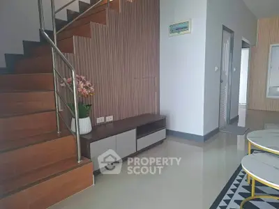 Modern interior with stylish staircase and sleek furniture in a contemporary home.