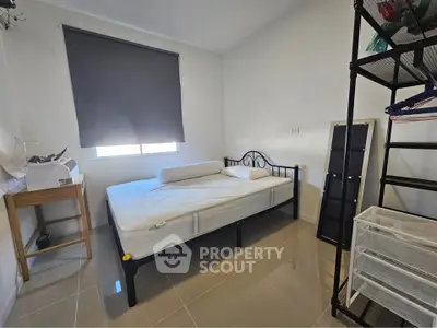 Cozy bedroom with modern metal bed frame and ample natural light