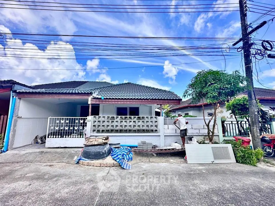 Charming suburban house with tiled roof and spacious driveway, ideal for family living.