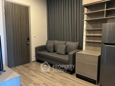 Modern living room with sleek gray sofa and stylish shelving, perfect for urban living.