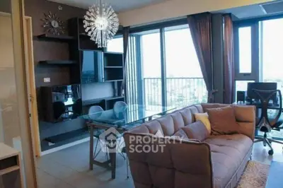 Modern living room with stylish decor and large windows offering city views.