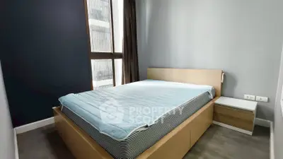 Modern bedroom with large window and minimalist design in urban apartment