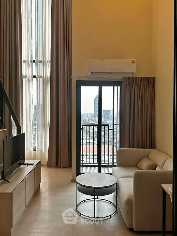 Modern living room with high ceilings and city view from balcony in luxury apartment.