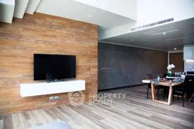 Modern living room with wooden accent wall and sleek dining area