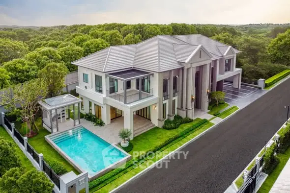 Luxurious modern mansion with private pool and lush greenery, perfect for upscale living.