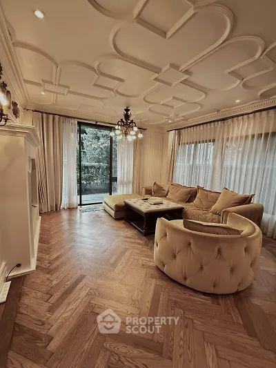Luxurious living room with elegant ceiling design and plush seating