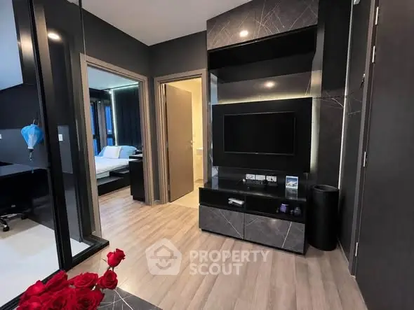 Modern living room with sleek design and open view to bedroom and bathroom