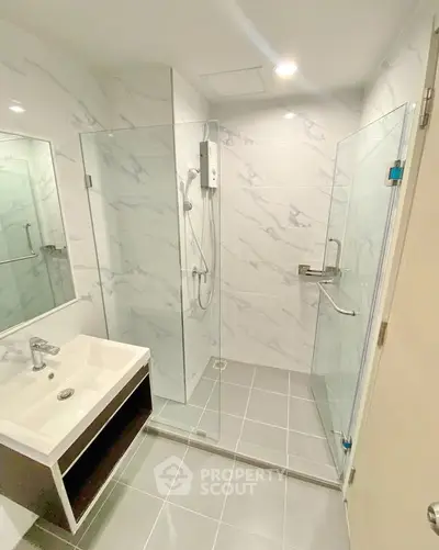 Modern bathroom with glass shower enclosure and sleek sink design