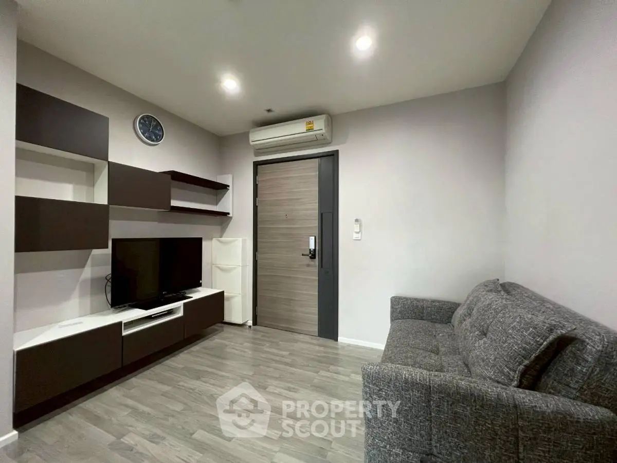 Modern living room with sleek furniture and air conditioning, perfect for comfortable living.