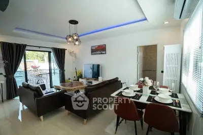 Spacious modern living room with elegant dining area and large windows for natural light.