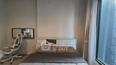 Modern bedroom with sleek design and large window offering city view