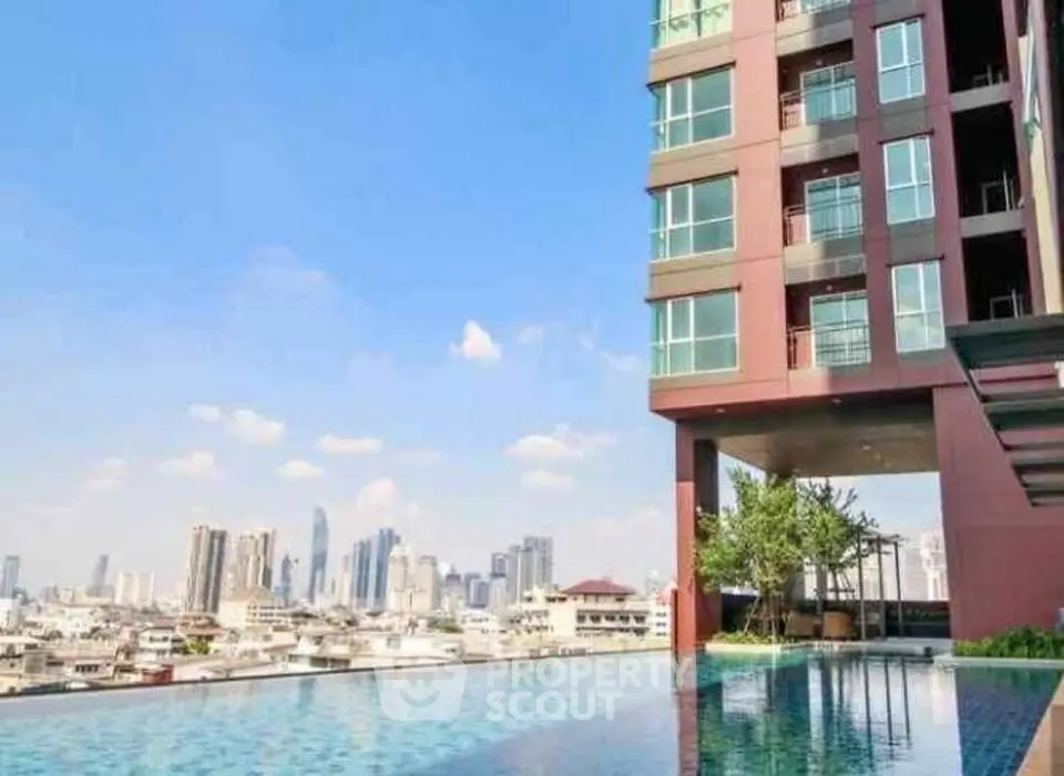 Luxurious high-rise building with stunning rooftop pool and city skyline view.