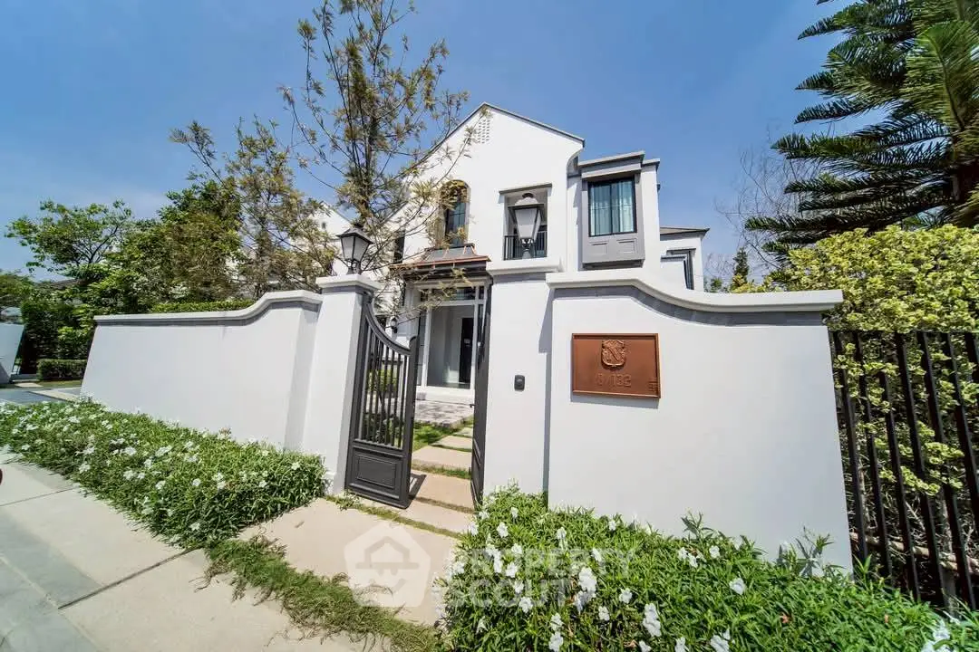 Stunning modern house exterior with lush garden and elegant entrance gate.