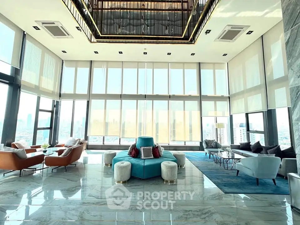 Luxurious high-rise living room with panoramic city views and elegant modern furnishings.