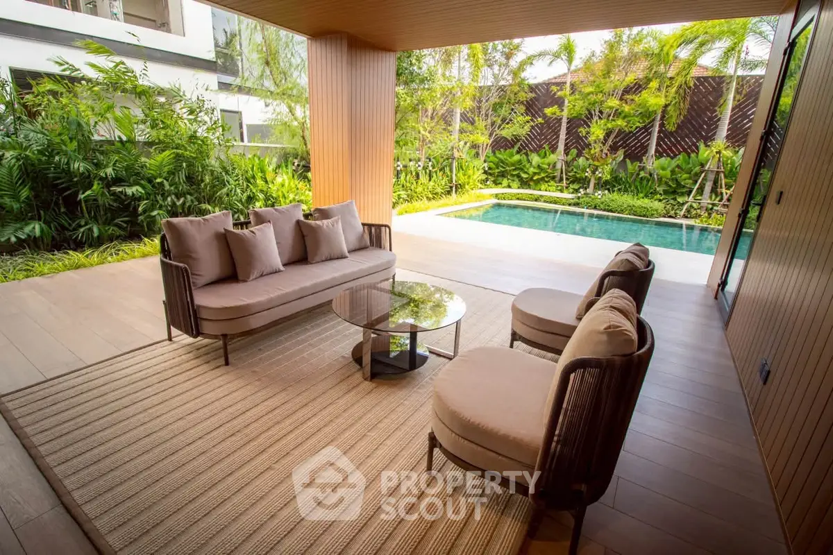 Luxurious outdoor patio with elegant seating and pool view in modern home