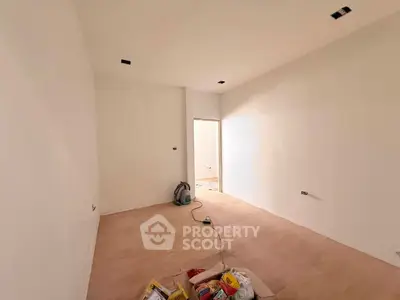 Spacious unfurnished room with white walls and wooden flooring, ideal for customization.