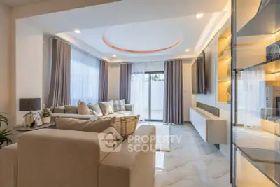 Luxurious modern living room with elegant decor and ample natural light.